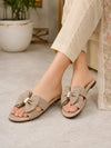 ZAYRA women's beige textured bow slippers with crystal brooch worn on feet with beige trousers