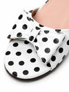 Close up macro shot of black polka dot bow tie on ZAYRA white flat slide strap