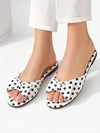 ZAYRA white and black polka dot flat slides for women worn with white trousers